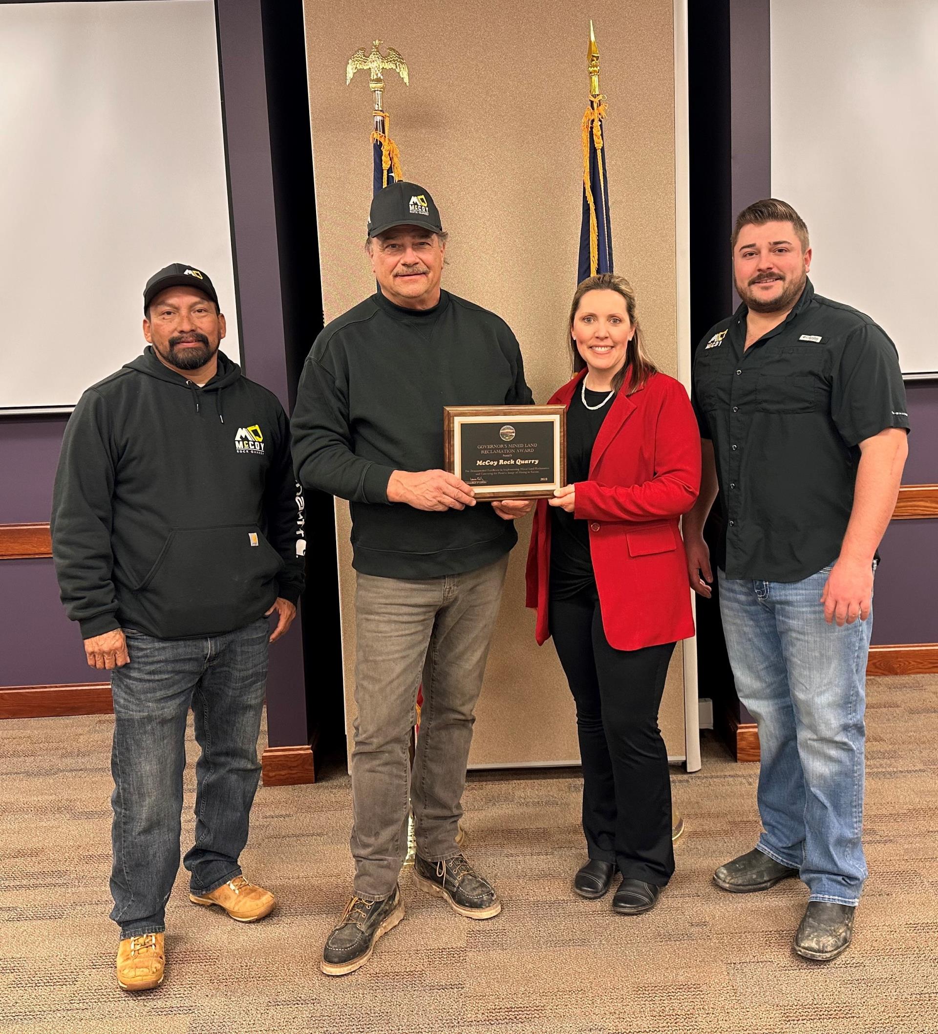 Christina Koelzer presents the Governors Mined Land Reclamation Award to McCoy Rock Quarry representatives Jaime Perez, Quarry Manager; Duane McCoy, President; and Dalton McCoy, Vice President